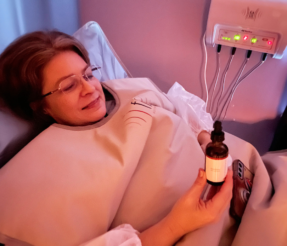 Client relaxing during a FIT Bodywrap infrared therapy session at Heat and Wellness Spa in Ripley, MS, supporting calorie burning, stress relief, muscle recovery, improved circulation, and overall wellness.