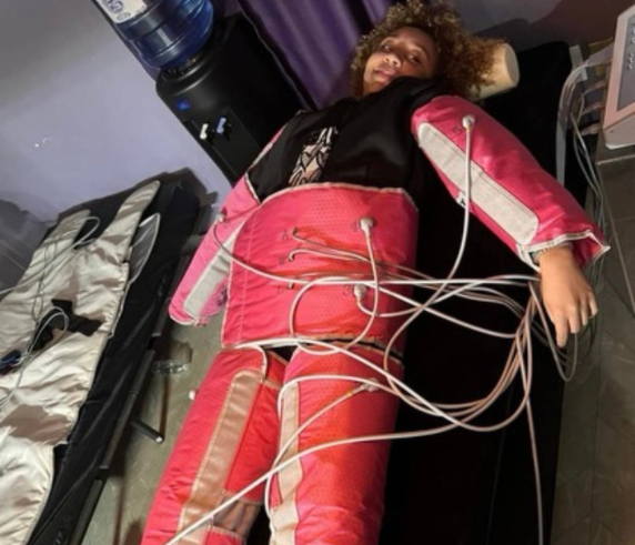 Client receiving a full-body pressotherapy compression therapy session at Heat and Wellness Spa in Ripley, MS to improve circulation, support lymphatic drainage, reduce bloating and water retention, and promote relaxation and recovery.