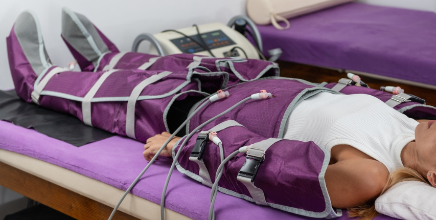 Client receiving a pressotherapy compression therapy treatment at Heat and Wellness Spa in Ripley, MS to support lymphatic drainage, improve circulation, reduce swelling, and promote muscle recovery.
