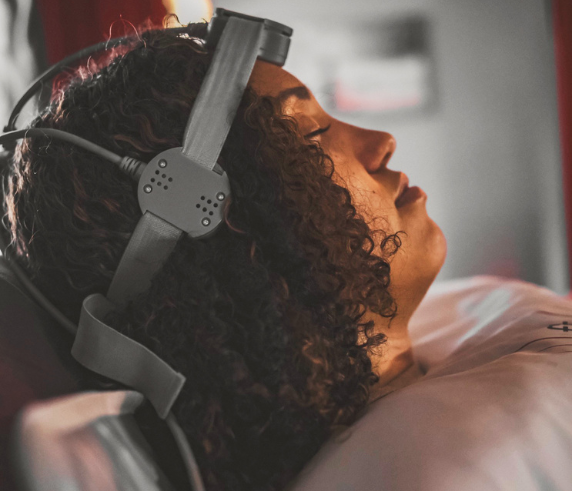 Client receiving a Repetitive Transcranial Magnetic Stimulation (rTMS) treatment at Heat and Wellness Spa in Ripley, MS using a non-invasive magnetic stimulation device to support brain health, mental clarity, focus, and overall cognitive wellness.
