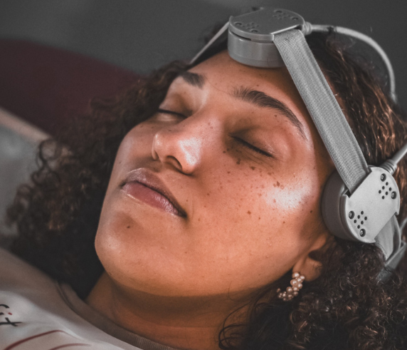 Client receiving a Repetitive Transcranial Magnetic Stimulation (rTMS) treatment at Heat and Wellness Spa in Ripley, MS using a non-invasive magnetic stimulation device to support brain health, mental clarity, focus, and overall cognitive wellness.