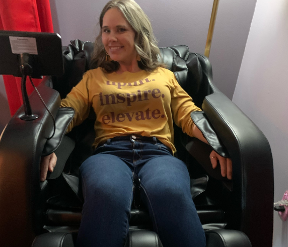 Client relaxing in a luxury massage chair at Heat and Wellness Spa in Ripley, MS during a therapeutic massage session designed to relieve muscle tension, reduce stress, improve circulation, and promote full-body relaxation.